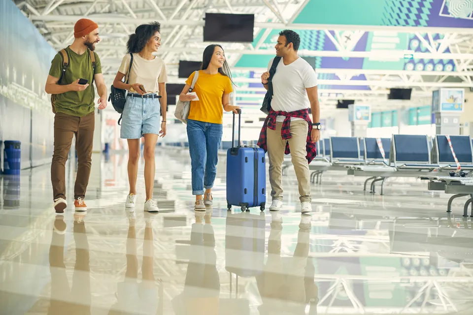 Group of travellers with luggage arriving together